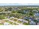 Neighborhood aerial view showcasing homes near community pool, pond and a central park at 1453 62Nd S Ter, St Petersburg, FL 33705