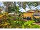 Backyard featuring lush lawn, tropical foliage, and a garden walkway at 1453 62Nd S Ter, St Petersburg, FL 33705