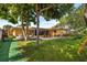 Large backyard featuring an outdoor patio and lush lawn area at 1453 62Nd S Ter, St Petersburg, FL 33705