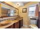Bathroom featuring dual sinks, granite counters, and a framed vanity mirror at 1453 62Nd S Ter, St Petersburg, FL 33705