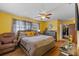 Comfortable bedroom featuring a ceiling fan, wood flooring and a walk-in closet at 1453 62Nd S Ter, St Petersburg, FL 33705