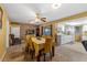 Dining room featuring a long table, brick wall, and white kitchen cabinetry at 1453 62Nd S Ter, St Petersburg, FL 33705