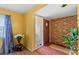 Entryway featuring a textured brick accent wall, window with blinds, tile flooring and closet at 1453 62Nd S Ter, St Petersburg, FL 33705