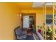 Inviting front porch with a cozy seating area and decorative plants in a sunny location at 1453 62Nd S Ter, St Petersburg, FL 33705
