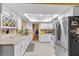 Kitchen featuring stainless appliances, white cabinetry, and granite countertops at 1453 62Nd S Ter, St Petersburg, FL 33705