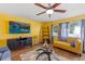 Cozy living room with hardwood floors, ceiling fan and a view of the outdoors at 1453 62Nd S Ter, St Petersburg, FL 33705