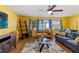 Spacious living room featuring hardwood floors, ceiling fan, and open access to other rooms at 1453 62Nd S Ter, St Petersburg, FL 33705