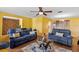 Cozy living room with two sofas, glass table, hardwood floors, and a ceiling fan at 1453 62Nd S Ter, St Petersburg, FL 33705