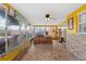 Bright sunroom featuring a unique tiled floor, ceiling fan and large windows at 1453 62Nd S Ter, St Petersburg, FL 33705