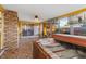 Cozy sunroom featuring a hot tub, tiled flooring, and bright yellow walls with windows at 1453 62Nd S Ter, St Petersburg, FL 33705