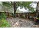 Cozy backyard featuring a wooden fence, mature trees, and lush foliage at 14985 Alan Ct, Largo, FL 33771