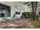 Scenic backyard with stone tiles, a fence and plants adjacent to the home's exterior at 14985 Alan Ct, Largo, FL 33771