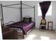 Stylish bedroom featuring a four-poster bed, window, chair, and elegant accents creating a cozy retreat at 14985 Alan Ct, Largo, FL 33771