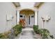 Front entrance to townhouses featuring decorative columns and landscaping at 14985 Alan Ct, Largo, FL 33771