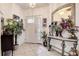 Bright foyer with tile floors, decorative mirror, and a colorful flower arrangement at 14985 Alan Ct, Largo, FL 33771