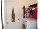 Small laundry room featuring a washer and clothes rack with an ironing board at 14985 Alan Ct, Largo, FL 33771