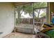 This enclosed patio overlooks the fenced in backyard and mature trees at 14985 Alan Ct, Largo, FL 33771
