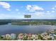 Stunning aerial view of the waterfront property and Wall Springs Park nearby at 150 Carlyle Dr, Palm Harbor, FL 34683