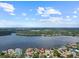 An aerial view highlighting the expansive waterfront property and lush green surroundings at 150 Carlyle Dr, Palm Harbor, FL 34683