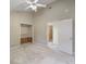 This large bedroom features a ceiling fan, closet with shelving, and doorway to bathroom at 150 Carlyle Dr, Palm Harbor, FL 34683