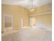Bright and open bedroom with closet, three doorways, and ceiling fan at 150 Carlyle Dr, Palm Harbor, FL 34683