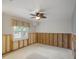 This bedroom features a ceiling fan, window with blind, and is ready for renovation at 150 Carlyle Dr, Palm Harbor, FL 34683