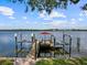 Waterfront home with a private boat dock and boat lift providing access to the open water at 150 Carlyle Dr, Palm Harbor, FL 34683