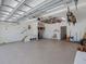 This spacious garage features a painted floor, side entrance door, and storage area at 150 Carlyle Dr, Palm Harbor, FL 34683