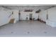 Spacious garage with painted floor, side entrance door, and storage area allows space for multiple cars at 150 Carlyle Dr, Palm Harbor, FL 34683