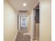 Hallway featuring light yellow walls, recessed lighting, and access to various rooms at 150 Carlyle Dr, Palm Harbor, FL 34683