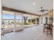 Beautiful screened-in lanai with tiled flooring offers a scenic view of the waterfront at 150 Carlyle Dr, Palm Harbor, FL 34683