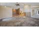 Spacious living room offers ample natural light and ceiling fan, ready for renovation at 150 Carlyle Dr, Palm Harbor, FL 34683