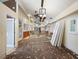 Large, open living room with french doors and exposed wall awaiting renovation and personalization at 150 Carlyle Dr, Palm Harbor, FL 34683