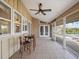 Covered outdoor lanai with ceiling fan and tiled floor features a seating area with views of the pool at 150 Carlyle Dr, Palm Harbor, FL 34683