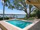 Backyard pool with dock access and waterfront views at 150 Carlyle Dr, Palm Harbor, FL 34683