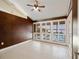 Light-filled sunroom with tiled floor, ceiling fan, and shuttered windows with pool views at 150 Carlyle Dr, Palm Harbor, FL 34683
