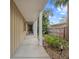 Covered walkway with lush landscaping at 150 Carlyle Dr, Palm Harbor, FL 34683