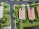Aerial view of a home with a tile roof, screened-in patio, and landscaped yard in a residential neighborhood at 16101 Cape Coral Dr, Wimauma, FL 33598