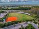 Aerial view of a baseball field with parking and surrounding landscaping at 16101 Cape Coral Dr, Wimauma, FL 33598