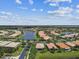 Wonderful community aerial showcasing lakefront properties, manicured lawns, and lush landscaping at 16101 Cape Coral Dr, Wimauma, FL 33598