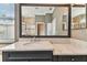 Bathroom featuring a grey vanity with granite countertops and large mirror reflecting the shower at 16101 Cape Coral Dr, Wimauma, FL 33598