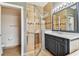 Bathroom featuring separate shower, grey vanity with granite countertops, and large framed mirror at 16101 Cape Coral Dr, Wimauma, FL 33598