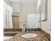 Bathroom features a granite countertop, wood cabinet, a bathtub with shower, and tiled accents at 16101 Cape Coral Dr, Wimauma, FL 33598
