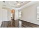 Spacious bedroom with tray ceilings, wood floors and large windows for natural light at 16101 Cape Coral Dr, Wimauma, FL 33598