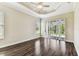 Spacious bedroom with wood floors, a ceiling fan, and sliding door access to outdoor living at 16101 Cape Coral Dr, Wimauma, FL 33598