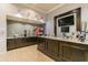 Cafe bar area featuring modern appliances, countertop space, and a mounted TV at 16101 Cape Coral Dr, Wimauma, FL 33598