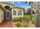 Home entrance showcasing a brick walkway and colorful landscaping at 16101 Cape Coral Dr, Wimauma, FL 33598