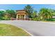 The beautiful entrance has a shaded portico and is surrounded by gorgeous landscaping and palm trees at 16101 Cape Coral Dr, Wimauma, FL 33598