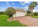 Charming single-story home boasting an attached garage, brick-paved driveway, and blossoming landscaping at 16101 Cape Coral Dr, Wimauma, FL 33598