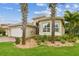 Beautiful single Gathering home with a lush lawn and elegant landscaping including palm trees at 16101 Cape Coral Dr, Wimauma, FL 33598